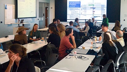 A group of people take part in a workshop in a conference room.